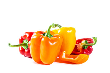 Mix of colorful whole and sliced ​​bell peppers. Isolated on white background.