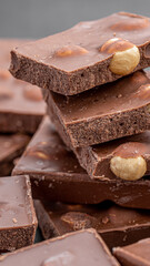 Chocolate cupcake with icing and chocolate bar in Dark lighting,Homemade delicious chocolate muffin on wooden background close-up