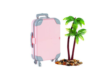 Travel pink suitcase on wheels and palm trees isolated on white.
