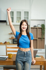Successful business woman, excited young woman Keeping up arms and showing positive emotions, happy...