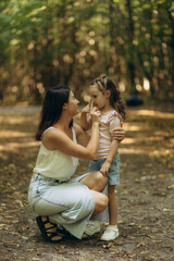 Mother and Daughter Enjoying Quality Time Together in a Scenic Forest Path