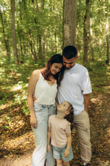 Fototapeta premium Family Enjoying a Peaceful Moment Together in a Lush Green Forest