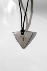 Unique Triangle Pendant Necklace with U on Black Cord. Fashionable and Modern Jewelry Design.