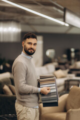 Man Presenting Fabric Swatches in a Modern Furniture Showroom