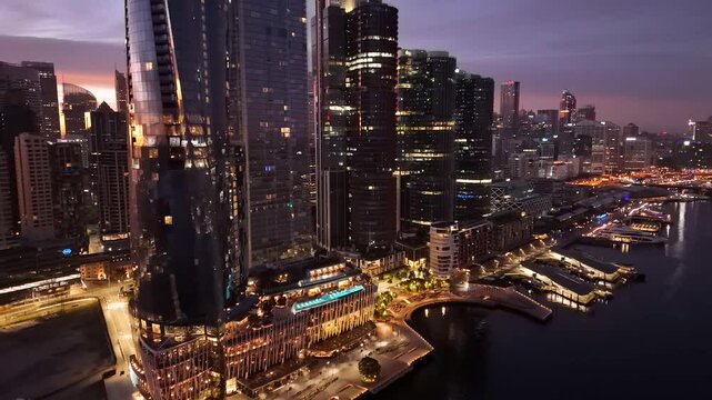 Aerial drone reverse view of Barangaroo waterfront precinct in Sydney City, NSW Australia during an early morning sunrise in July 2025     