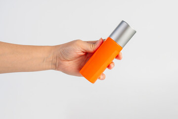 Skin care or sunscreen cosmetic and hand on white background.