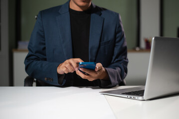 Businessman using on smartphone and tablet and laptop at office