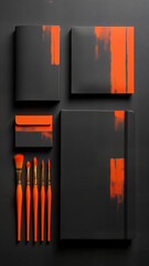Top view of black and orange flat lay workspace designer.