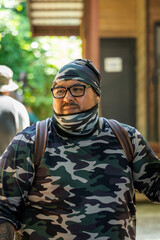 Fototapeta premium Latin tourist in camouflage clothing and hiking backpack in tropical destination of Corcovado, Costa Rica