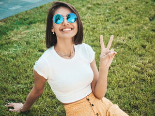 Portrait of beautiful smiling brunette model dressed in summer hipster  clothes. Trendy female...