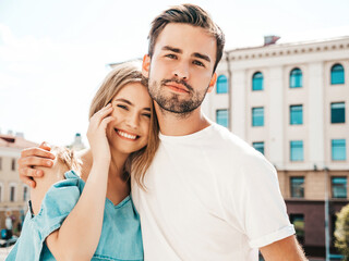 Portrait of smiling beautiful woman and her handsome boyfriend. Woman in casual summer jeans dress...