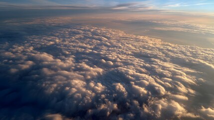 Naklejka premium Aerial view of fluffy clouds during sunset, showcasing vibrant colors and serene atmosphere