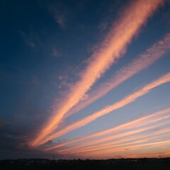 Fototapeta premium Beautiful sunset sky with vibrant orange and pink streaks, clouds scattered, tranquil rural landscape