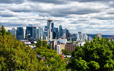 Iconic view of the Seattle skyline from Kerry Park with modern skyscrapers beneath a dramatic sky,...