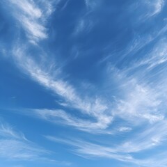 Fototapeta premium Expansive blue sky with wispy clouds creating a serene atmosphere, ideal for relaxation or inspiration