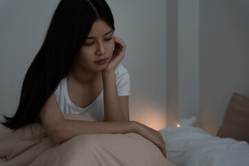 asian woman in bed late trying to sleep suffering insomnia, sleepless or scared in a nightmare,...