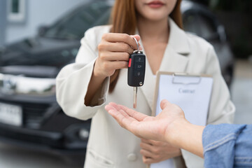 lease, rental car, sell, buy. Dealership manager send car keys to the new owner.  Sales, loan...