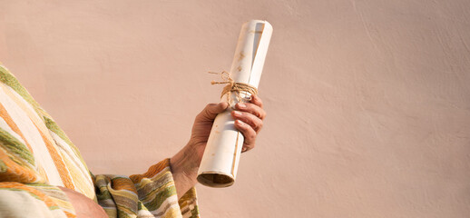 Male hand holding an old scroll