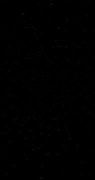 Stars sparkling in a black sky. 4K Vertical