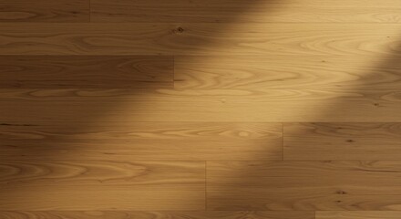 Wooden floor with natural grain individual planks and varying lightdark areas from shadows