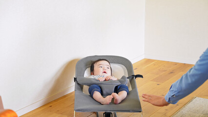 Baby sleeping in a bouncer