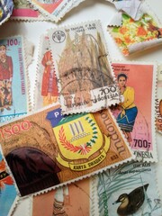 
A Collection of Colorful Indonesian Postage Stamps Arranged Closely Together

