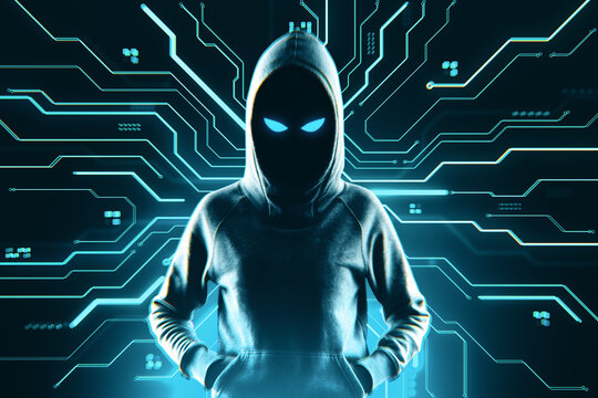 Anonymous hooded hacker figure with glowing eyes standing against digital circuit background symbolizing cybercrime and online security threat.