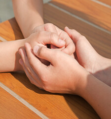 Close-up view of comforting hands