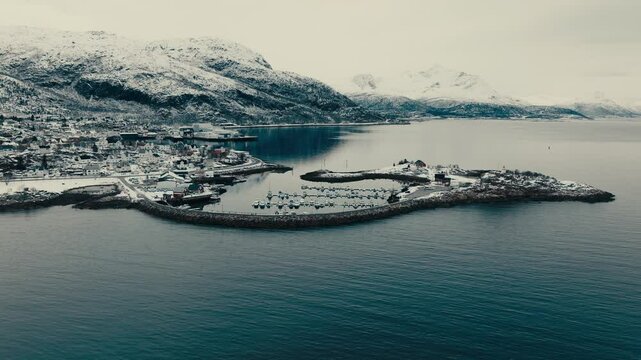 Boats Moored In The Marina Of Lodingen Village in Winter in Norway. - aerial shot
