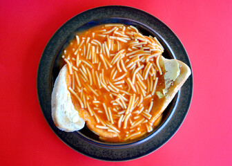  top view of tinned spaghetti on lightly toasted bread with butter.