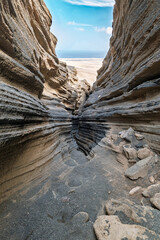 Unique volcanic rock formations at Las Grietas in Lanzarote. Deep cracks and fissures carved into...