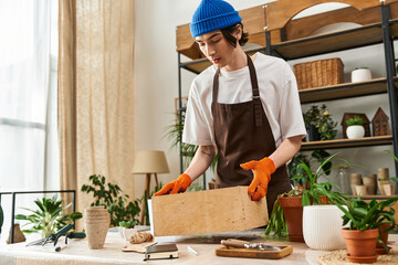 Young man tending to plants in a bright studio, nurturing nature with care