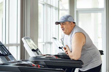 man in sportswear experiencing chest pain at the gym. Man experiencing sudden heartache while...