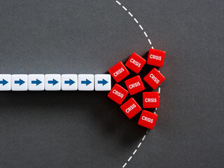 Row of white dice with arrows pointing to red dice forming a roadblock with the word crisis