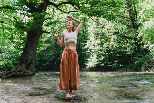 Woman practicing meditation in a serene forest setting