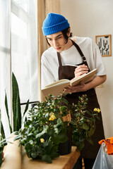 Handsome young man nurturing plants in a cozy studio environment, taking notes for care tips