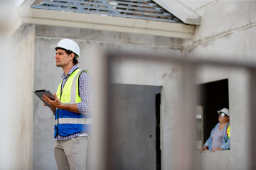 Engineer builder. Foreman work in construction site. Construction site manager standing wearing...
