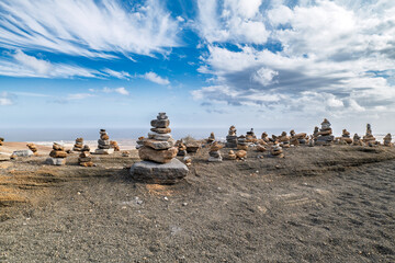 Abstract stone figures carefully stacked in Las Grietas, Lanzarote. These balanced rock formations...