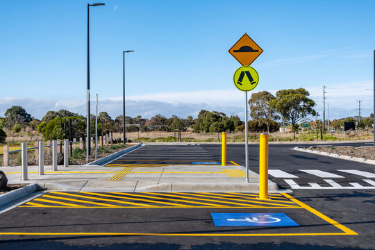 A disabled parking bay in a public car park with a designated pedestrian and accessible crossing. Inclusive urban infrastructure and safety planning in Australia. - Powered by Adobe