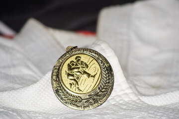 Karate medal on kimono – Honor and sporting discipline