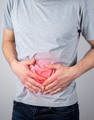 Person holding stomach experiencing abdominal pain