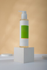Dispenser Cosmetics bottle mockup on concrete cube stand, yellow background. Unbranded beauty container, blank green label template. copy space