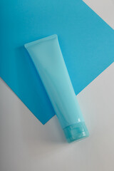 Blue Cosmetics tube mockup on white background. Unbranded beauty container, no label template....