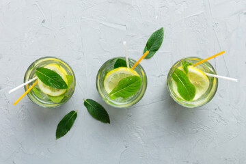 Caipirinha, Mojito cocktail, vodka or soda drink with lime, mint and straw on table background....