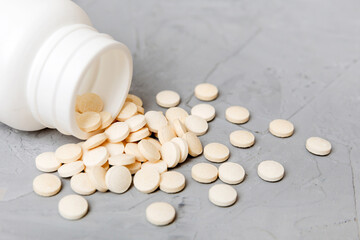 different drugs and health supplement pills poured from a medicine bottle health care and medical...
