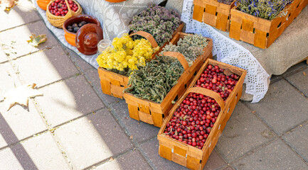 Market stall filled with fresh produce and dried herbs. The vibrant colors of the cranberries and...