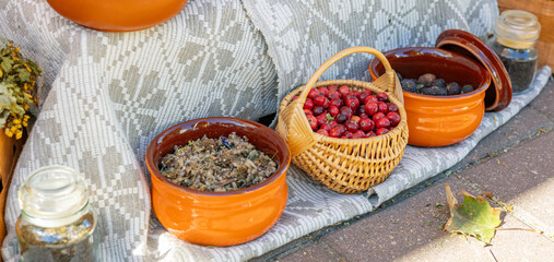Market stall filled with fresh produce and dried herbs. The vibrant colors of the cranberries and...