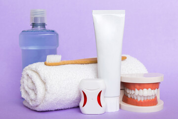 Mouthwash and other oral hygiene products on colored table top view with copy space. Flat lay....