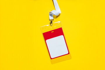 ID badge with lanyard on yellow background. Simple design with space for name or info, symbolizing...