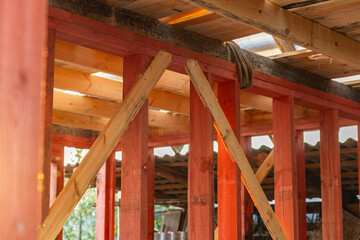  lose-up of a wooden roof frame during construction. The wooden planks are arranged in a grid...